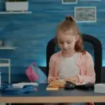 student studying effectively at desk with books and laptop