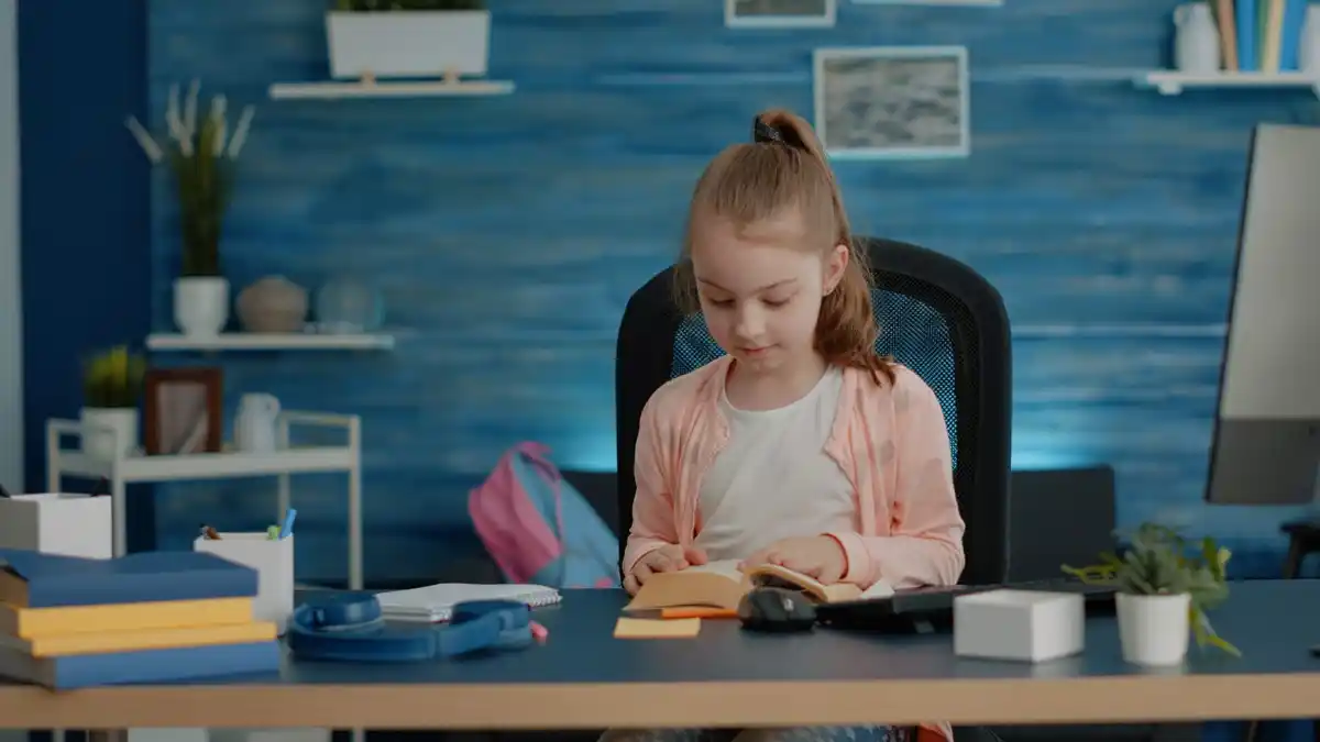 student studying effectively at desk with books and laptop