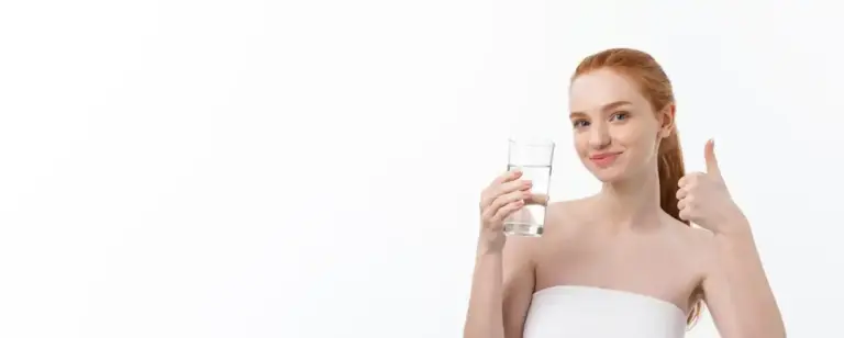 woman drinking water glowing skin