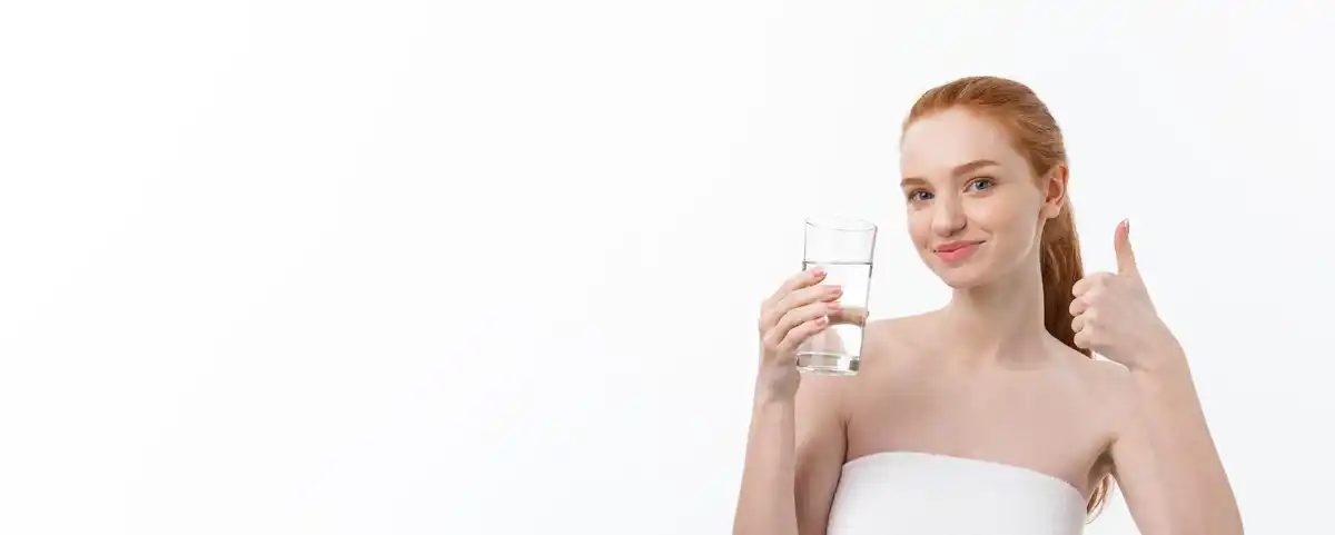 woman drinking water glowing skin