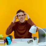 student working at desk with distractions