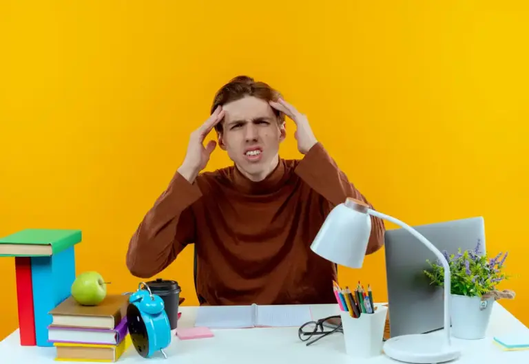 student working at desk with distractions