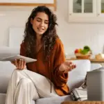 happy person using multiple gadgets at home