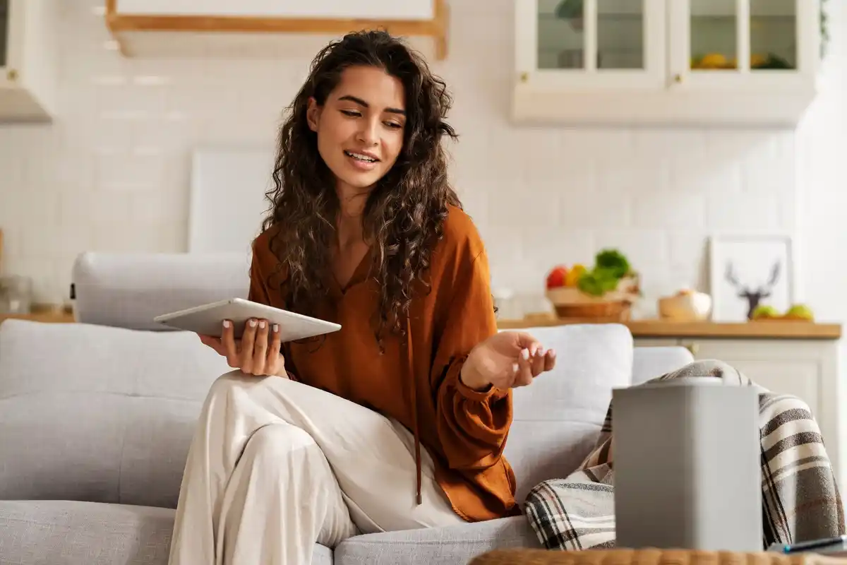 happy person using multiple gadgets at home